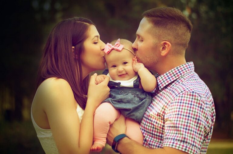 About NCJ Brokers web page Featured Image - Picture of mother and father kissing their baby.